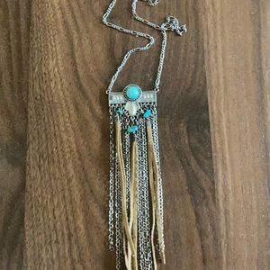 Long boho necklace with turquoise and faux leather detail; silver hardware.